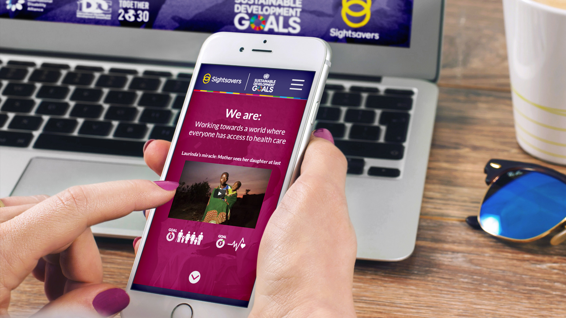 Mobile device showing the website design in use by a person 